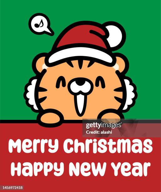 a cute tiger wearing a santa hat holds a sign and wishes you a merry christmas and a happy new year - new year cartoon stock illustrations