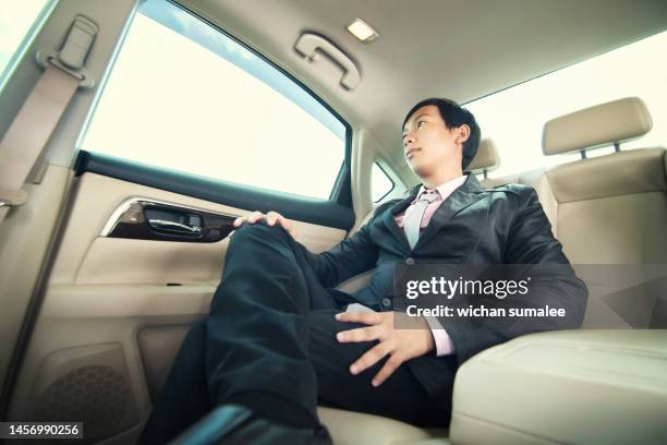 businessman sitting in luxury car. - limousine stock pictures, royalty-free photos & images