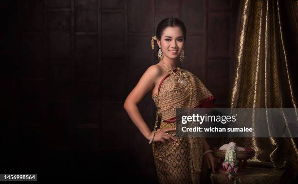 asian girls in thai cultural costumes - thai tradition stock pictures, royalty-free photos & images