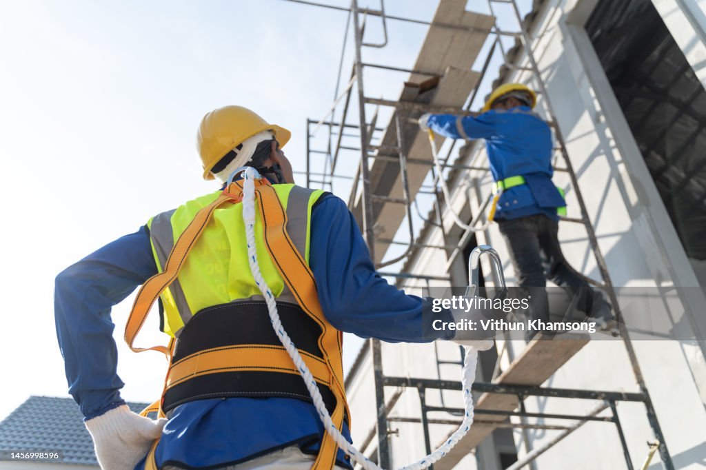 Using Harness Two Workers Working At Height And Safety Harness At Construction Site ...
