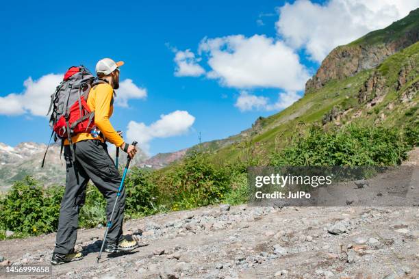 young adult man hiking in mountains alone - caucasus stock pictures, royalty-free photos & images