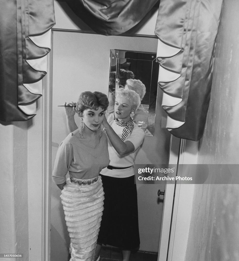 Debra Pachet American actress Debra Paget, wearing long drop earrings, her hands ...