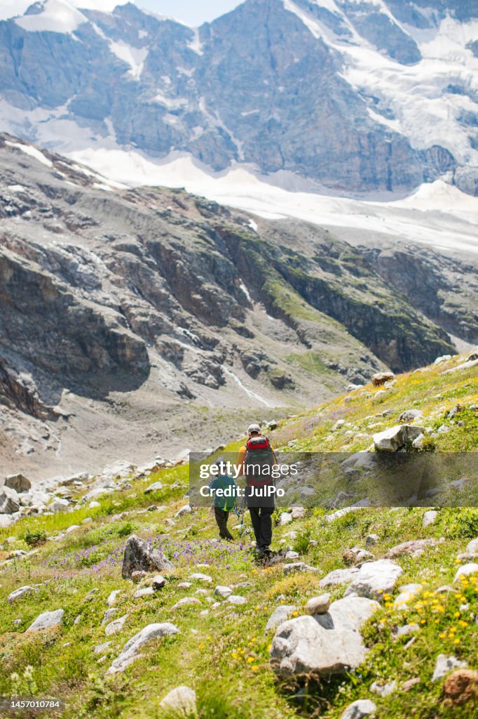 Father and son hiking in mountains together