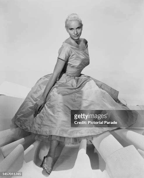 American actress Eva Marie Saint wearing a short sleeve evening gown, against a white background, United States, circa 1955.