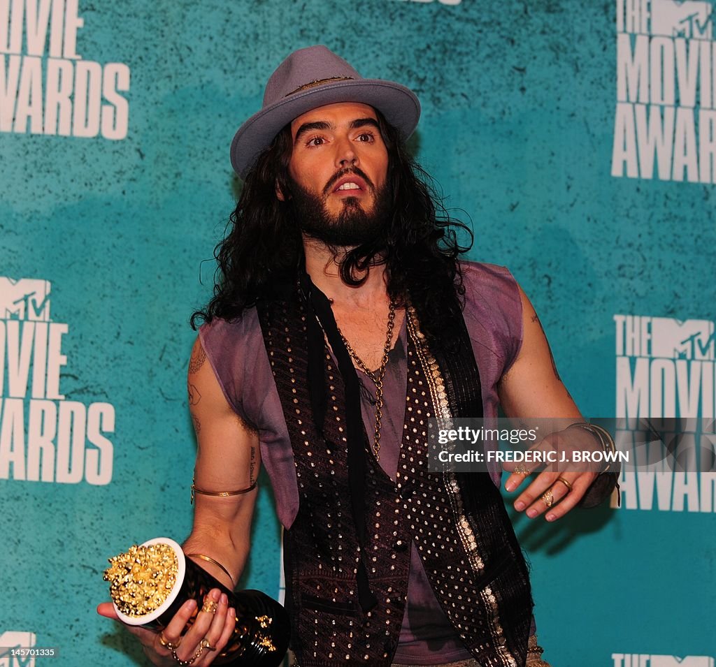 Host Russell Brand poses in the press ro