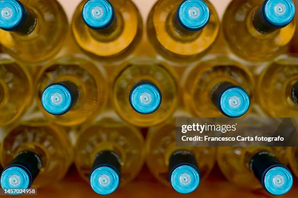 white wine bottles in wine cellar - vin blanc photos et images de collection