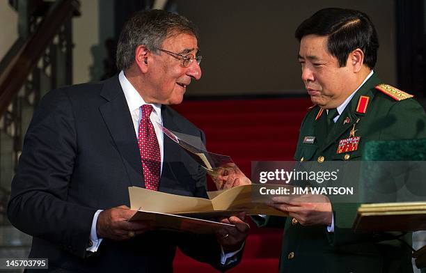 Vietnamese Minister of Defense Phuong Quang Thanh receives the Vu Dinh Doan diary, which was taken by US Marine Robert Frazure following Operation...