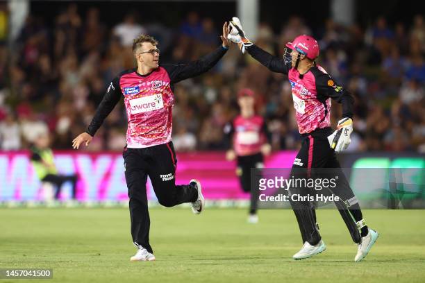 Todd Murphy of the Sixers celebrates dismissing Matt Short of the Strikers during the Men's Big Bash League match between the Sydney Sixers and the...
