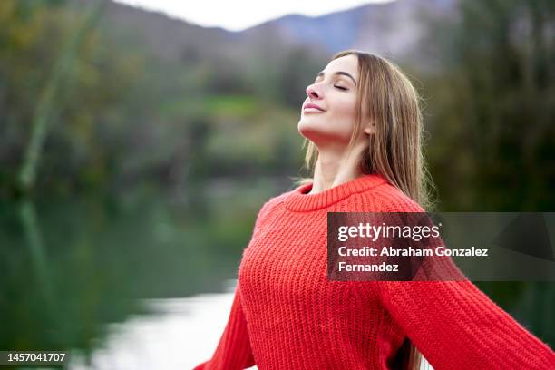 woman with closed eyes breathes calm and relaxed. - open workouts imagens e fotografias de stock