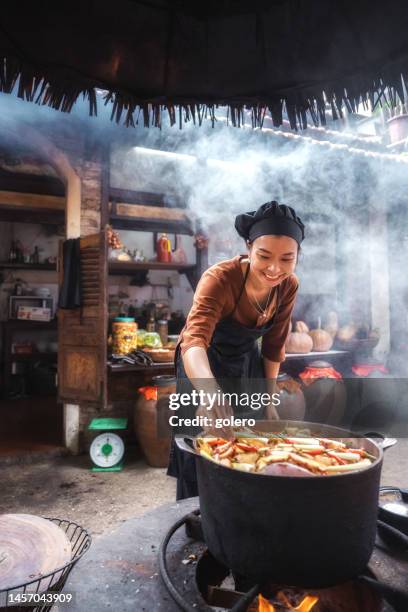 young vietnamese female chef cooking on open fire in restaurant - hot vietnamese women stock pictures, royalty-free photos & images