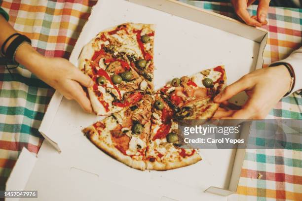 top view people grabbing pizza slices - cheese top view stockfoto's en -beelden