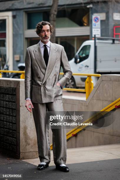 Richard Biedul is seen wearing white shirt, tie, grey silk double-breasted Giorgio Armani suit and black loafer outside the Giorgio Armani show...