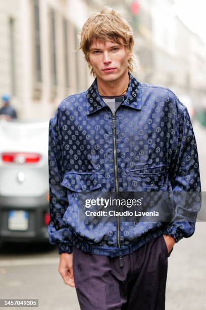 Jordan Barrett is seen wearing blue silk zipped jacket and purple silk pants outside the Giorgio Armani show during the Milan Menswear Fall/Winter...