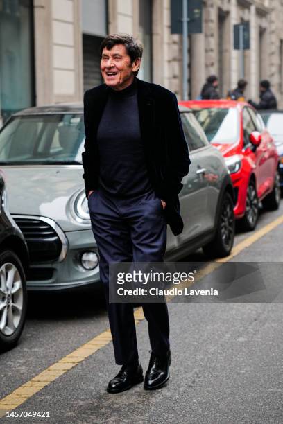 Gianni Morandi is seen wearing blue suit pants, black sweater and black velvet jacket outside the Giorgio Armani show during the Milan Menswear...