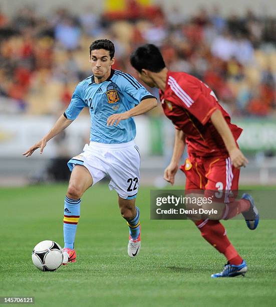 Jesus Navas of Spain tries to get past Sun Xiang of China during the International Friendly match between Spain and China at La Cartuja stadium on...