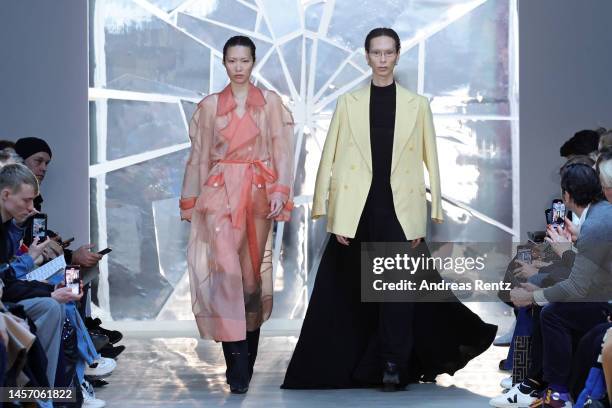 Models walk the runway, model on the left wearing coat by Tribal Hotel, body by Anekdot, shoes by Anima Protection, and on the right blazer by...