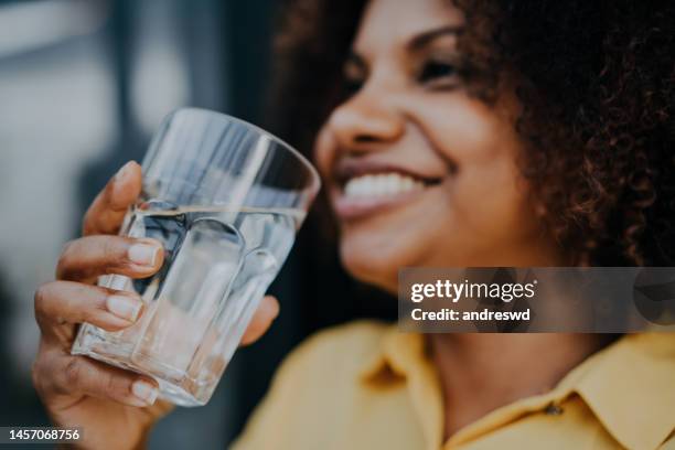 woman drinking drinking water - drinking glass of water stock pictures, royalty-free photos & images