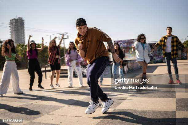 young man breakdancing during street party with her friends outdoors - rap bildbanksfoton och bilder