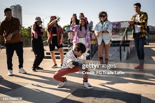 Child boy breakdancing during street party with her friends outdoors Child boy breakdancing during street party with her friends outdoors