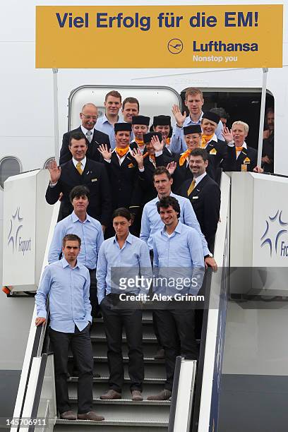 Head coach Joachim Loew and players of the German national football team pose with the crew in front of the airplane prior to their departure to...