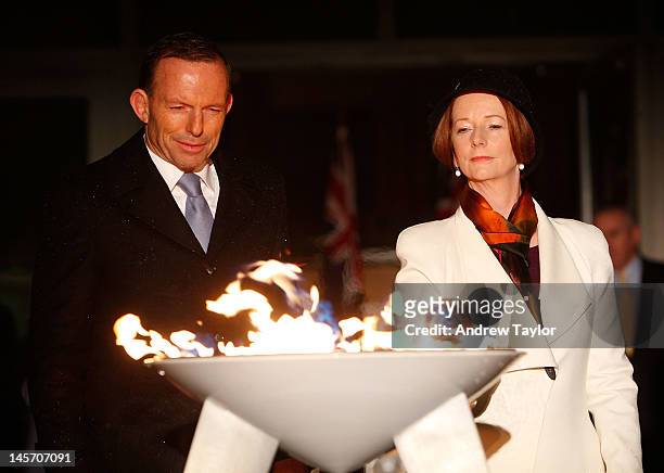 Australian Prime Minister Julia Gillard and opposition Leader Tony Abbott jointly light a ceremonial beacon to mark the Queen's Diamond Jubilee at...