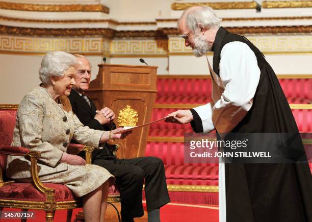 Britain's Queen Elizabeth II , accompanied by Prince Philip, Duke of Edinburgh, receives a copy of the loyal address from Archbishop of Canterbury...