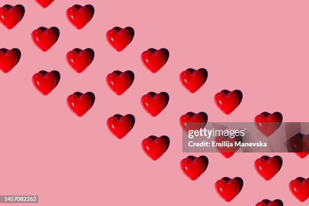 red hearts background - candy hearts stock pictures, royalty-free photos & images