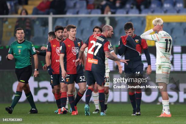 The Referee Gianpiero Miele and Dennis Johnsen of Venezia FC look on as Alessandro Vogliacco of Genoa CFC's team mates attempt to calm him following...
