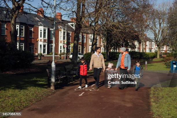 family time in the park - walkers spell & go stock pictures, royalty-free photos & images