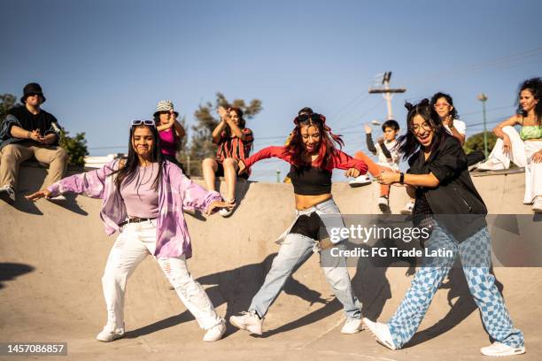 friends dancing and having fun during street party at skateboard park - straatfeest stockfoto's en -beelden