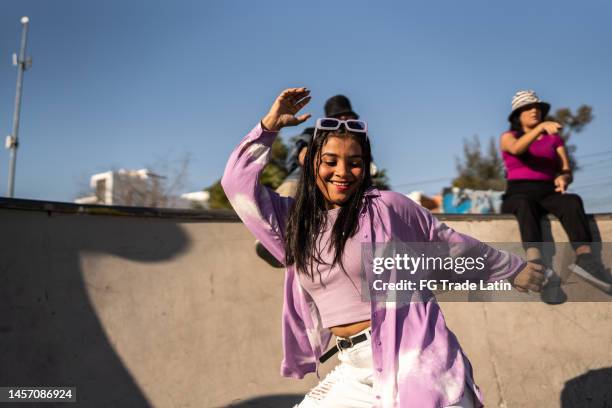young woman dancing and having fun during street party - cool attitude youth stock pictures, royalty-free photos & images