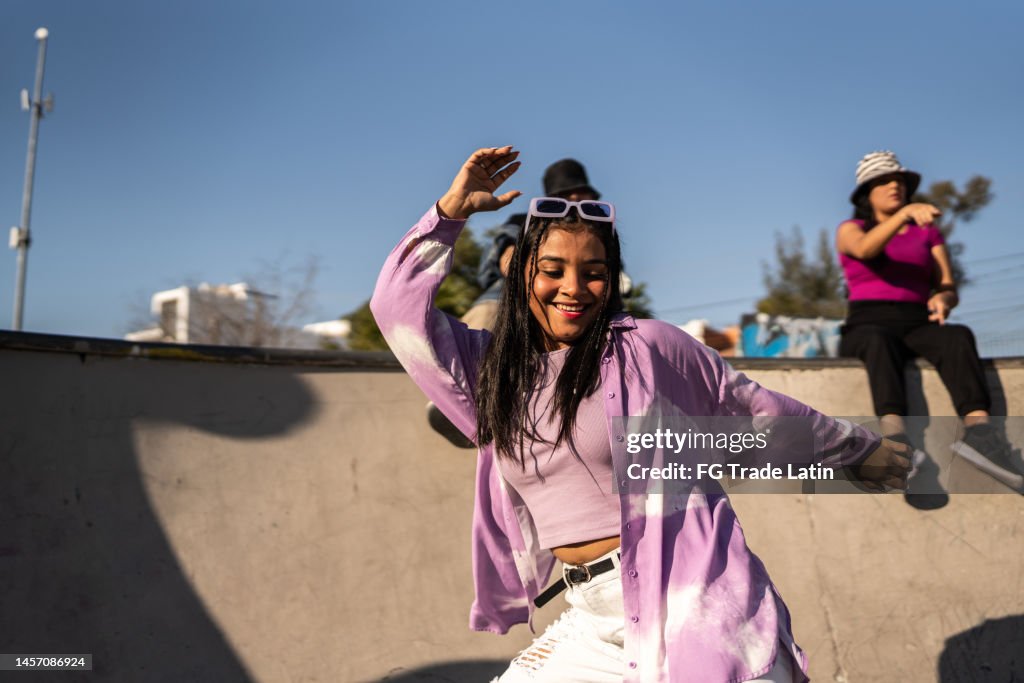 Young woman dancing and having fun during street party