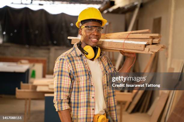 carpenter working on woodworking machines in carpentry shop. profession, carpentry, woodwork and people concept - woodwork stock pictures, royalty-free photos & images