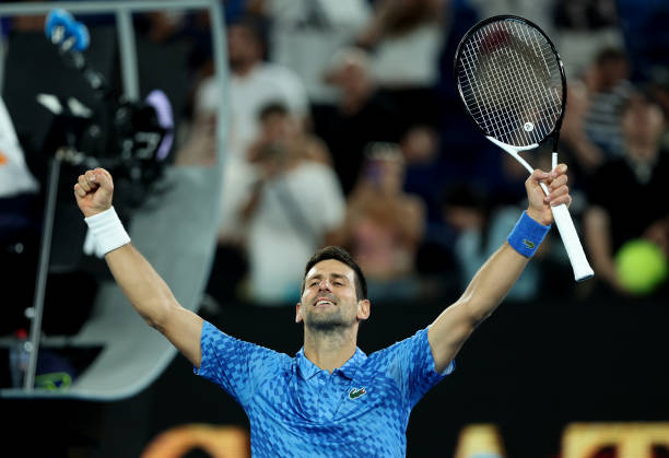 Novak Djokovic of Serbia celebrates to the crowd after his victory in their round one singles match against Roberto Carballes Baena of Spain during...