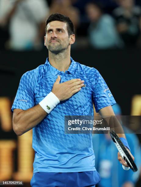 Novak Djokovic of Serbia celebrates to the crowd after his victory in their round one singles match against Roberto Carballes Baena of Spain during...