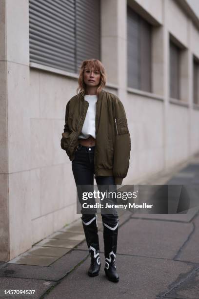 Nadine Berneis seen wearing Black Palms the label jeans pants, Alhoas black and white high boots and a olive green HERNAMEIS the label jacket on...