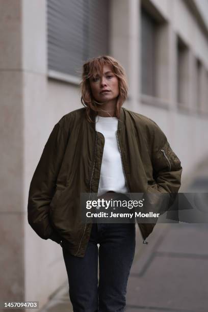 Nadine Berneis seen wearing Black Palms the label jeans pants, Alhoas black and white high boots and a olive green HERNAMEIS the label jacket on...