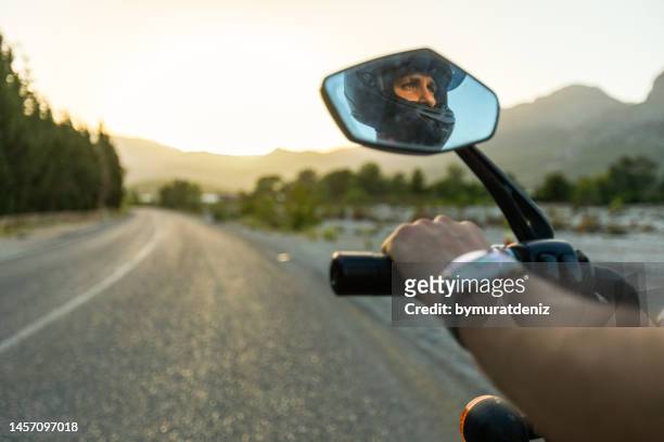 hombre en el espejo retrovisor de una motocicleta - holiday scooter fotografías e imágenes de stock