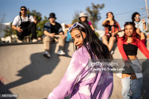 portrait of young woman dancing at street party - street style fashion stock pictures, royalty-free photos & images