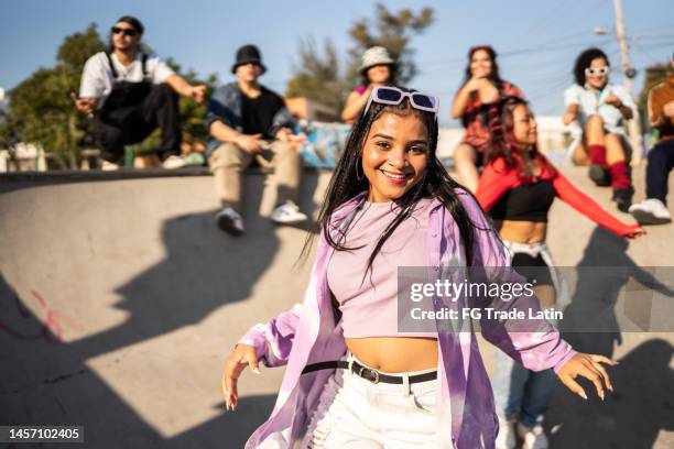 portrait of young woman dancing and having fun at street party - gangsta rappers stock pictures, royalty-free photos & images