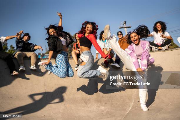 friends jumping and having fun during street party at skateboard park - rap stock pictures, royalty-free photos & images