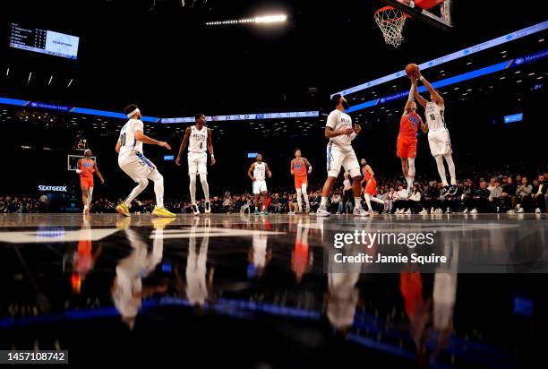 Yuta Watanabe of the Brooklyn Nets and Lindy Waters III of the Oklahoma City Thunder compete for a rebound during the game at Barclays Center on...