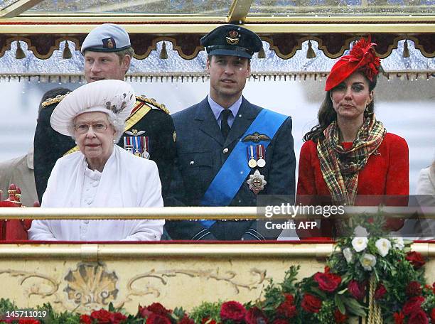 Britain's Queen Elizabeth, Prince Harry, Prince William and Catherine, Duchess of Cambridge, watch from onboard the royal barge "Spirit of Chartwell"...