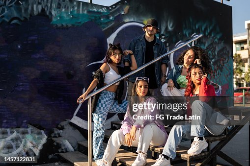 Portrait of hip hop group on staircase outdoors