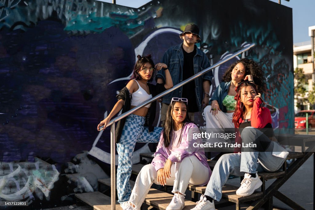 Portrait of hip hop group on staircase outdoors