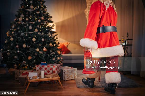 santa claus with a lantern - christmas arrival stock pictures, royalty-free photos & images