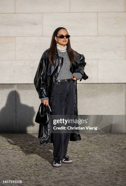 Anna Winter wears Frankie Shop coat in black, Uterque turtleneck, grey COS knit, Closed belt, Weekday jeans, Adidas sneaker, YSL sunglasses, By Far...