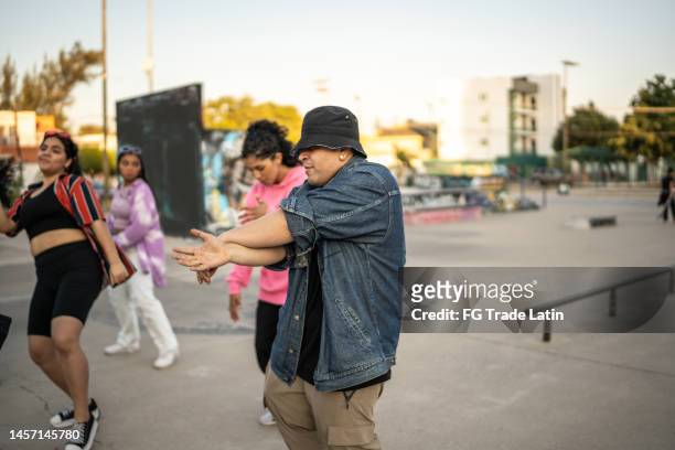 young man dancing hip hop with her friends at skateboard park - fab fragment stock pictures, royalty-free photos & images