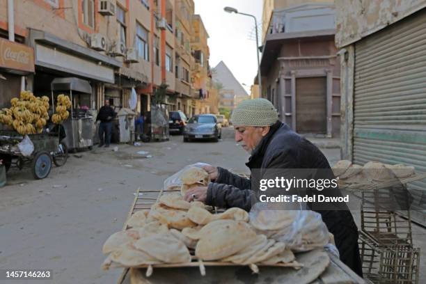 Man selling bread on January 17, 2023 in Nazlet El-Semman near the pyramids Giza, Egypt. The Egyptian pound suffered its biggest one-day drop on...