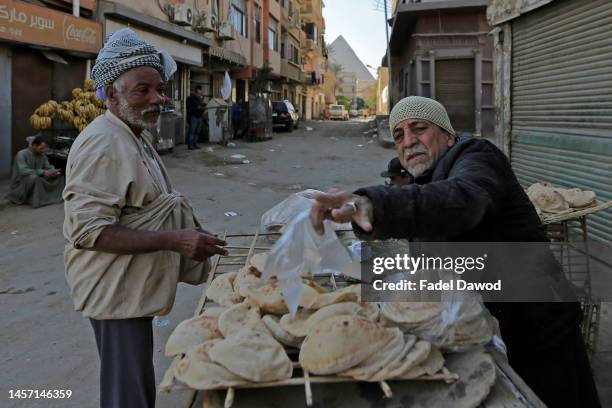 Man selling bread on January 17, 2023 in Nazlet El-Semman near the pyramids Giza, Egypt. The Egyptian pound suffered its biggest one-day drop on...